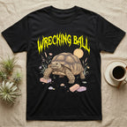 Sulcata Tortoise Feral T-Shirt in Black — Sulcata tortoise plodding over crumbled bricks under a jagged caution-yellow metal "WRECKING BALL" wordmark.