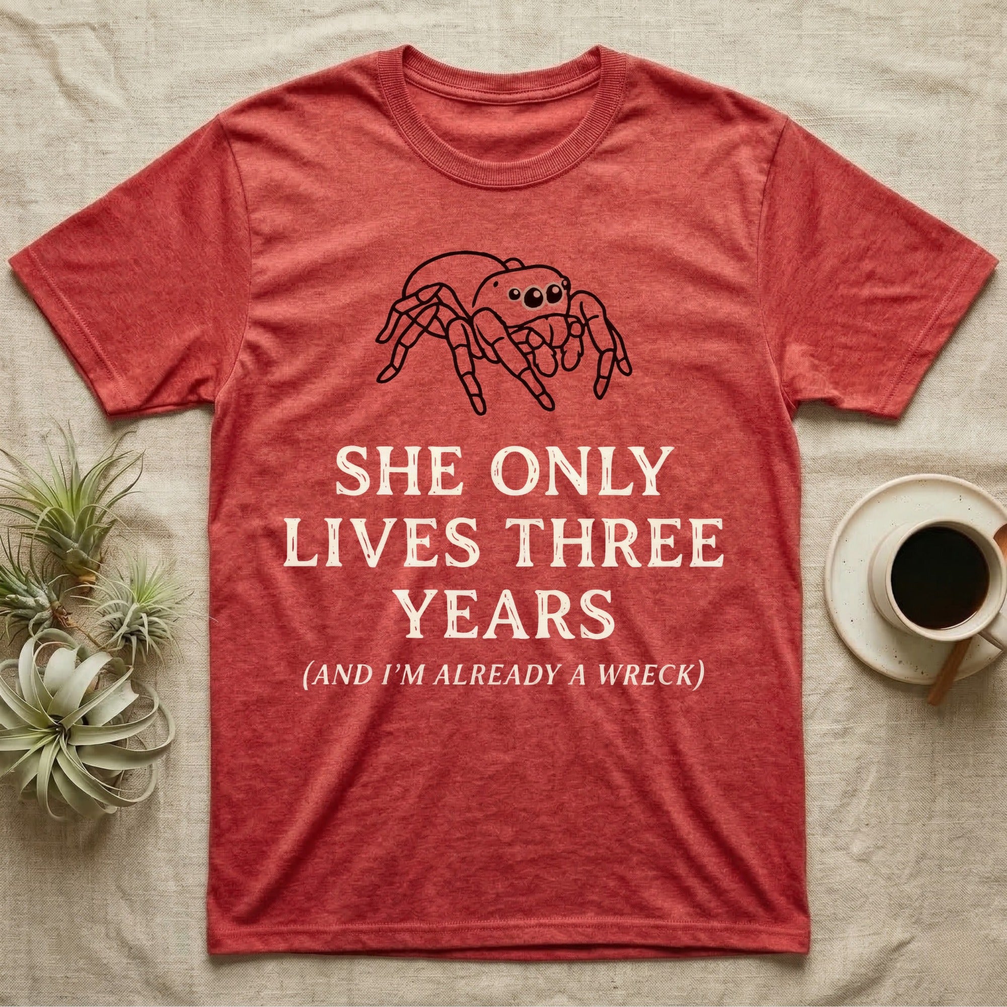 Jumping Spider Three Years Tee in Heather Red — Vintage-ink Phidippus jumping spider portrait above type "She Only Lives Three Years (And I'm Already A Wreck)."