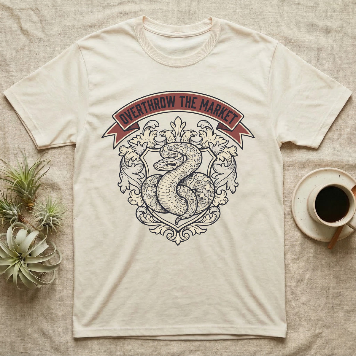 Overthrow The Market Python T-Shirt in Natural — Vintage heraldic-crest illustration of a regal ball python with a banner reading "Overthrow The Market."