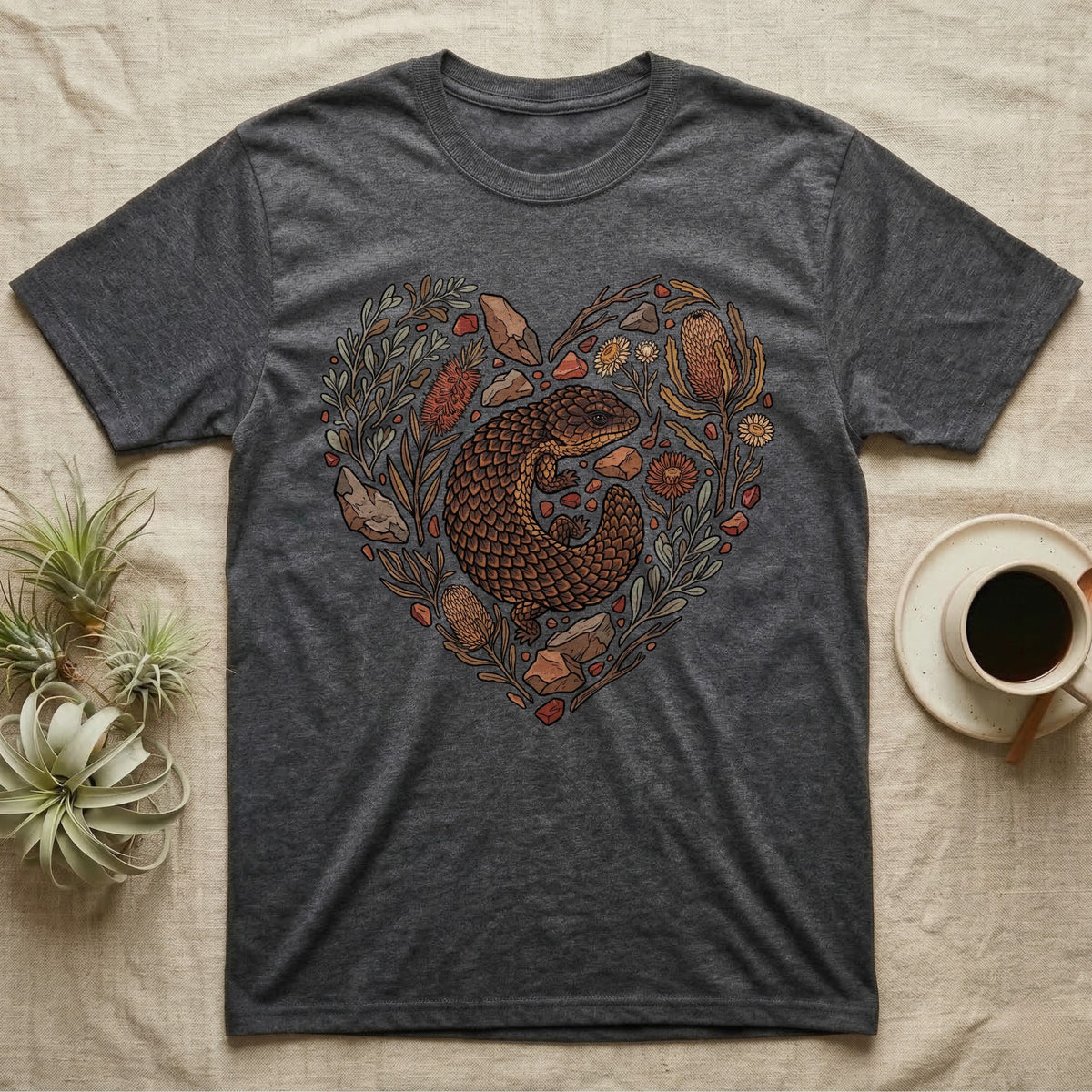 Dark grey t-shirt with heart-shaped Australian flora and fauna design.