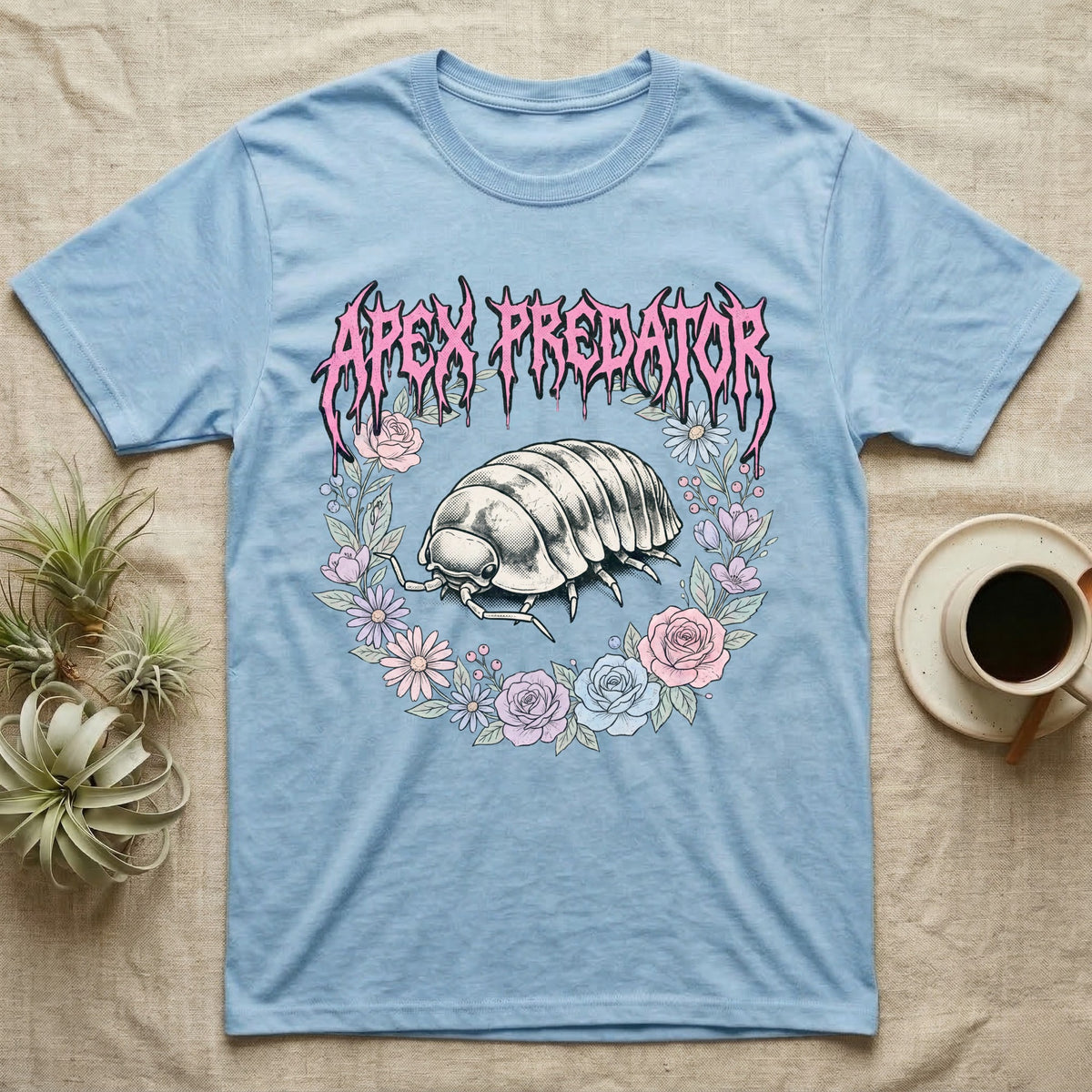 Apex Predator Isopod T-Shirt in Light Blue — Bootleg design of a cute isopod in a floral wreath under dripping death-metal lettering reading "Apex Predator."