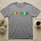 Green Tree Python Canopy Crew T-Shirt in Sport Grey — Watercolor illustration of a green tree python in seven real colour-change stages coiled on a branch, dark grey T-shirt design.
