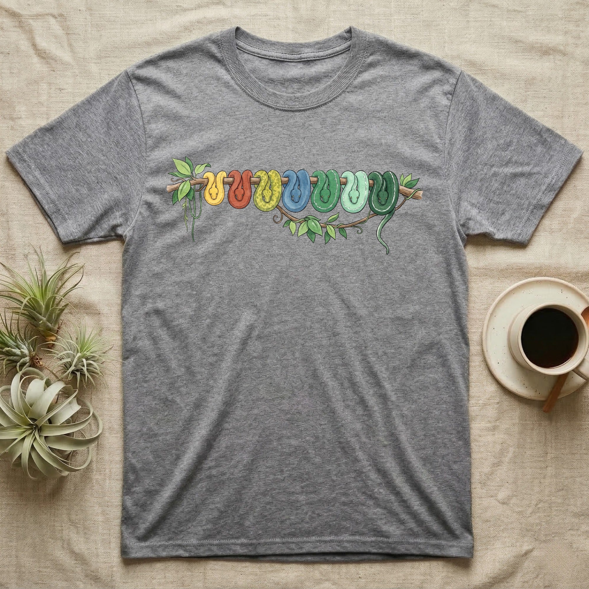 Green Tree Python Canopy Crew T-Shirt in Sport Grey — Watercolor illustration of a green tree python in seven real colour-change stages coiled on a branch, dark grey T-shirt design.