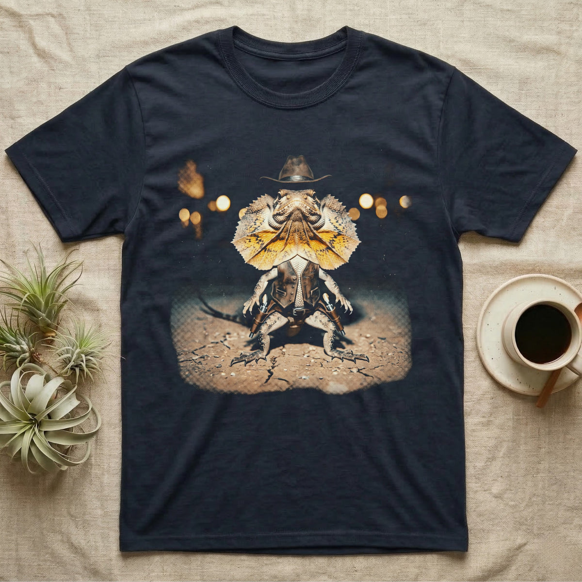 Frilled Lizard Outlaw T-Shirt in Navy — Frilled lizard as a Wild West outlaw in a cowboy hat and twin holsters, frill flared, on cracked desert ground.
