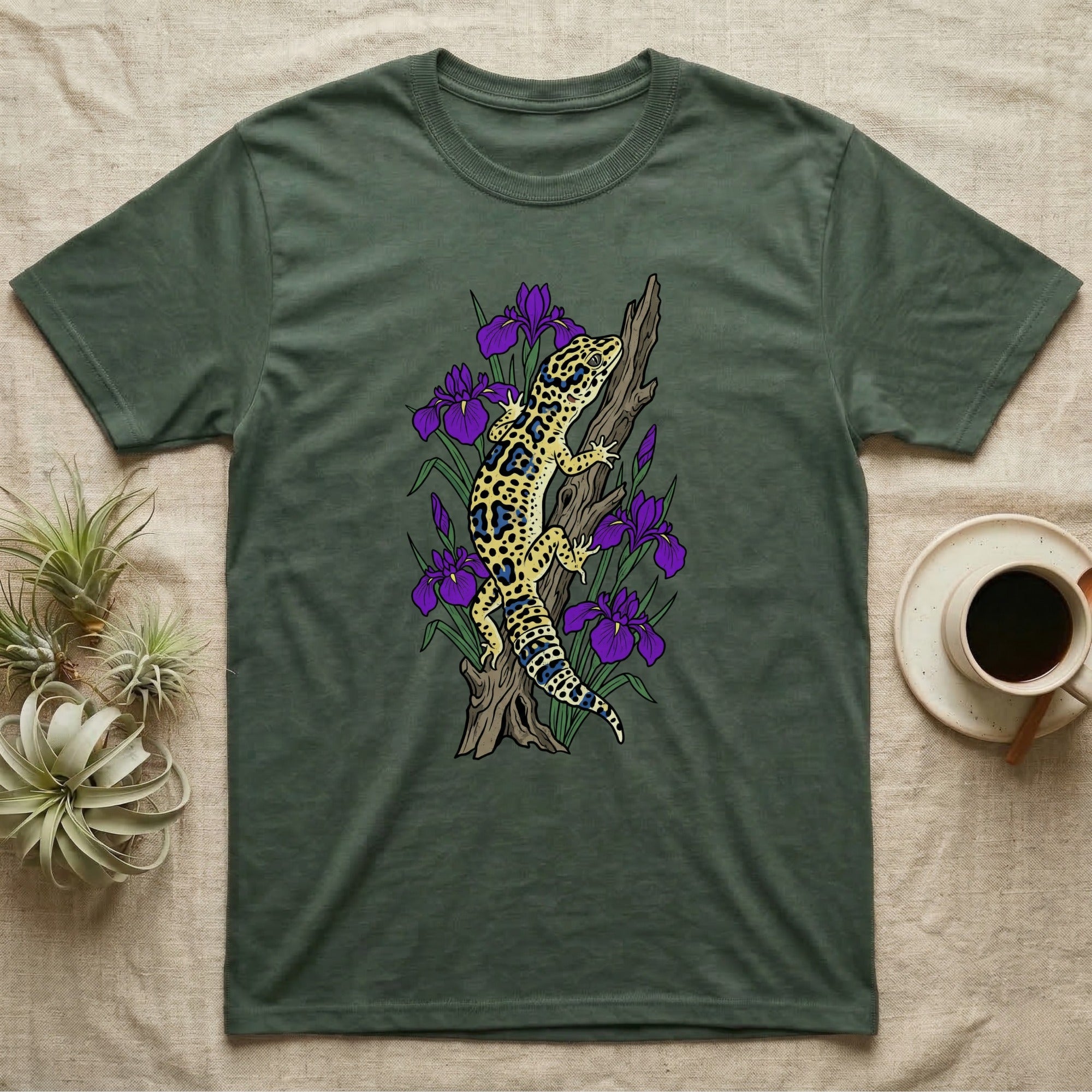 Green t-shirt with a leopard gecko on a branch with purple irises.