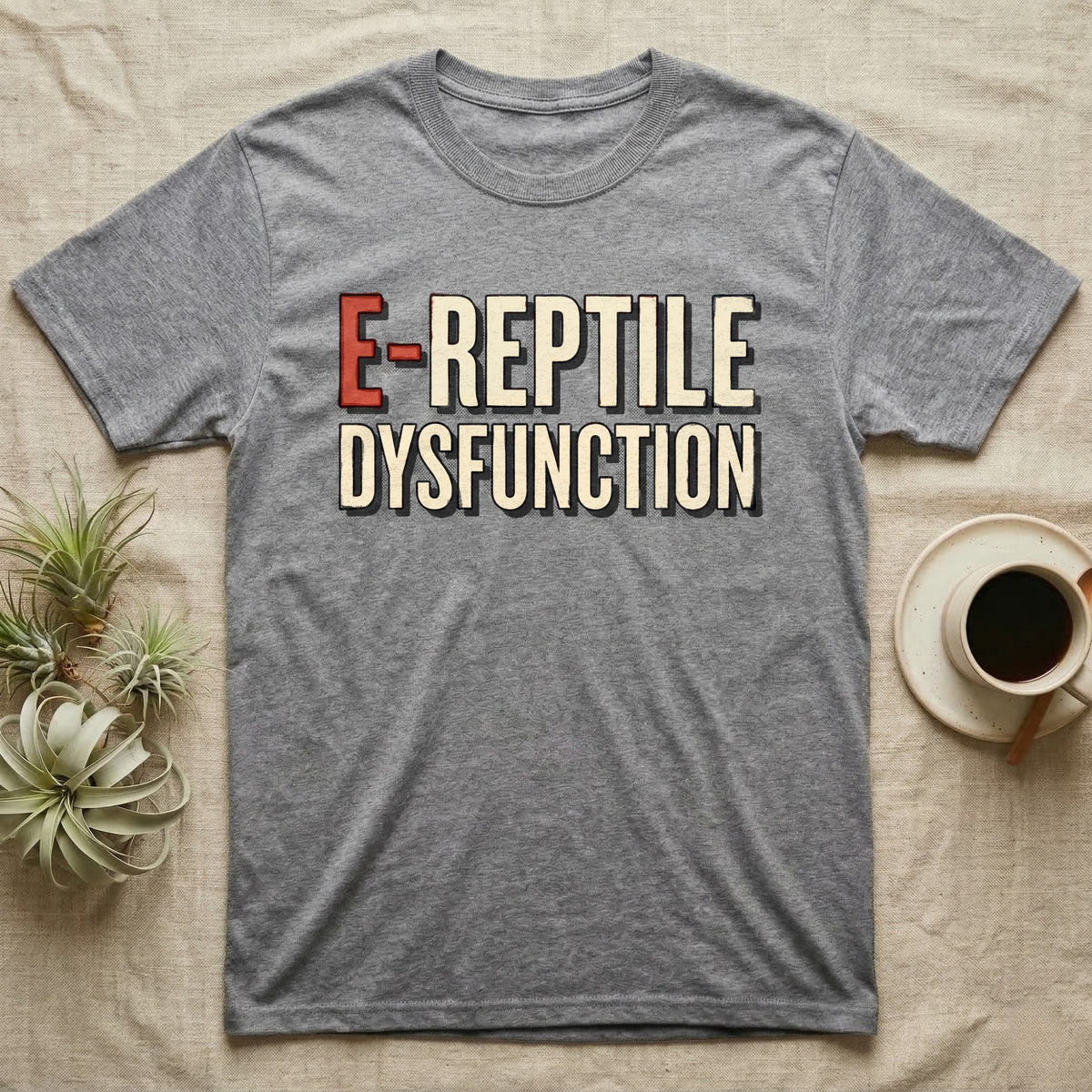 E-Reptile Dysfunction Gecko T-Shirt in Sport Grey — Retro-pharmacy typographic wordmark reading "E-Reptile Dysfunction" in distressed cream and tomato-red lettering.