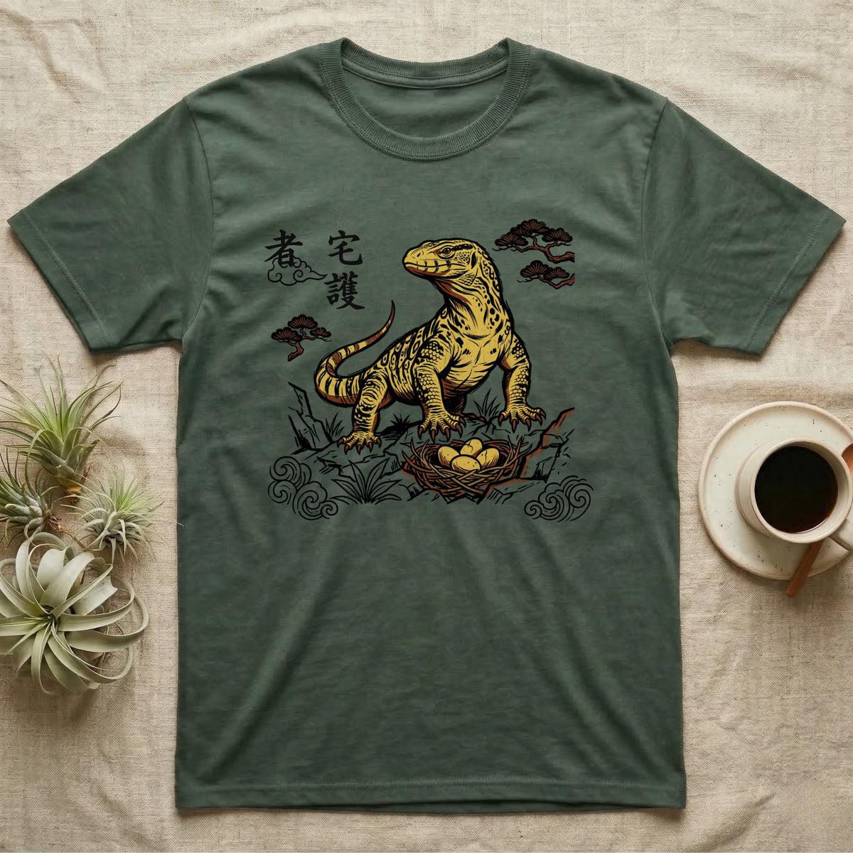 Green t-shirt with a yellow komodo dragon on a nest of eggs.