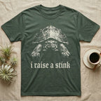 Musk Turtle Stink T-Shirt in Military Green — Photo of a small musk turtle facing forward above the blackletter line i raise a stink