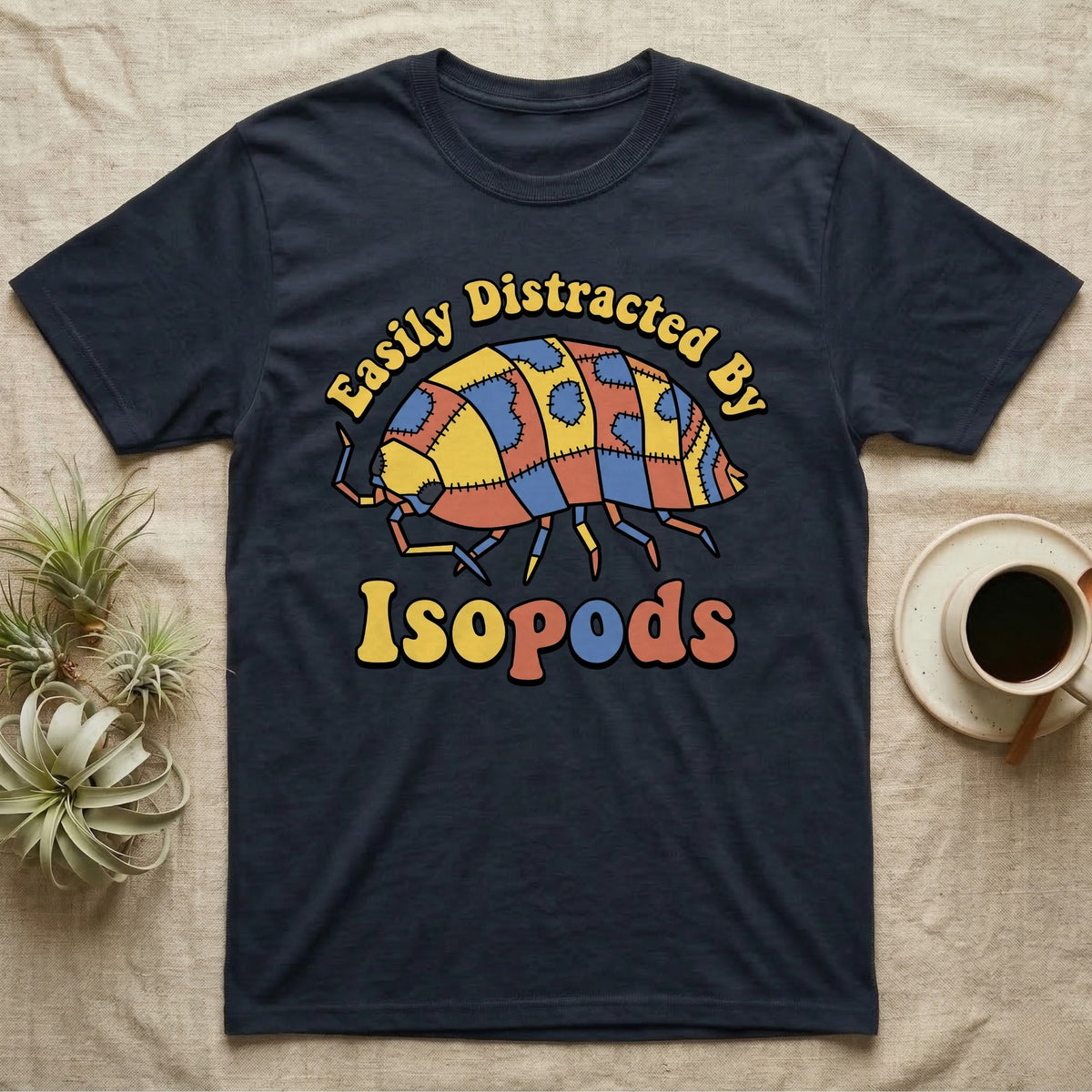 Dairy Cow Isopod Patchwork T-Shirt in Navy — Quilt-patchwork dairy cow isopod in mustard and denim under retro "Easily Distracted By Isopods" text.