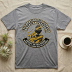 Bearded Dragon 1776 T-Shirt in Sport Grey — Bold woodcut tee of a bearded dragon in a tricorn hat black-bearding on a rock, gold and cream banner reading the lizards run the economy.