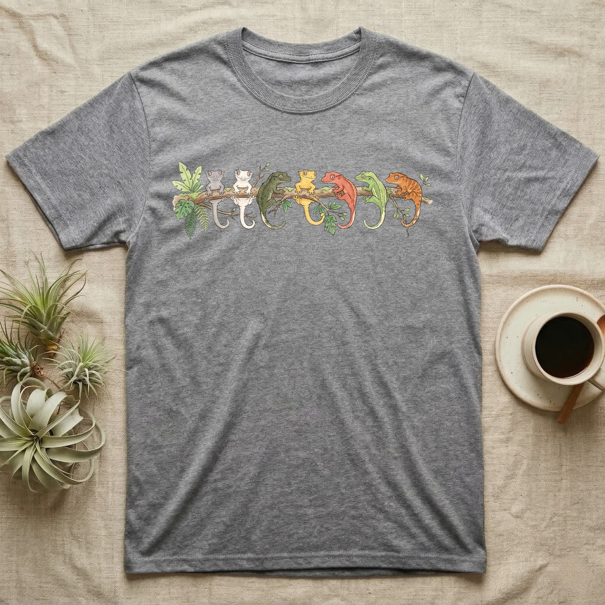 Crested Gecko Canopy Crew T-Shirt in Sport Grey — Watercolor illustration of seven crested gecko colour morphs perched on a branch, dark grey T-shirt design.