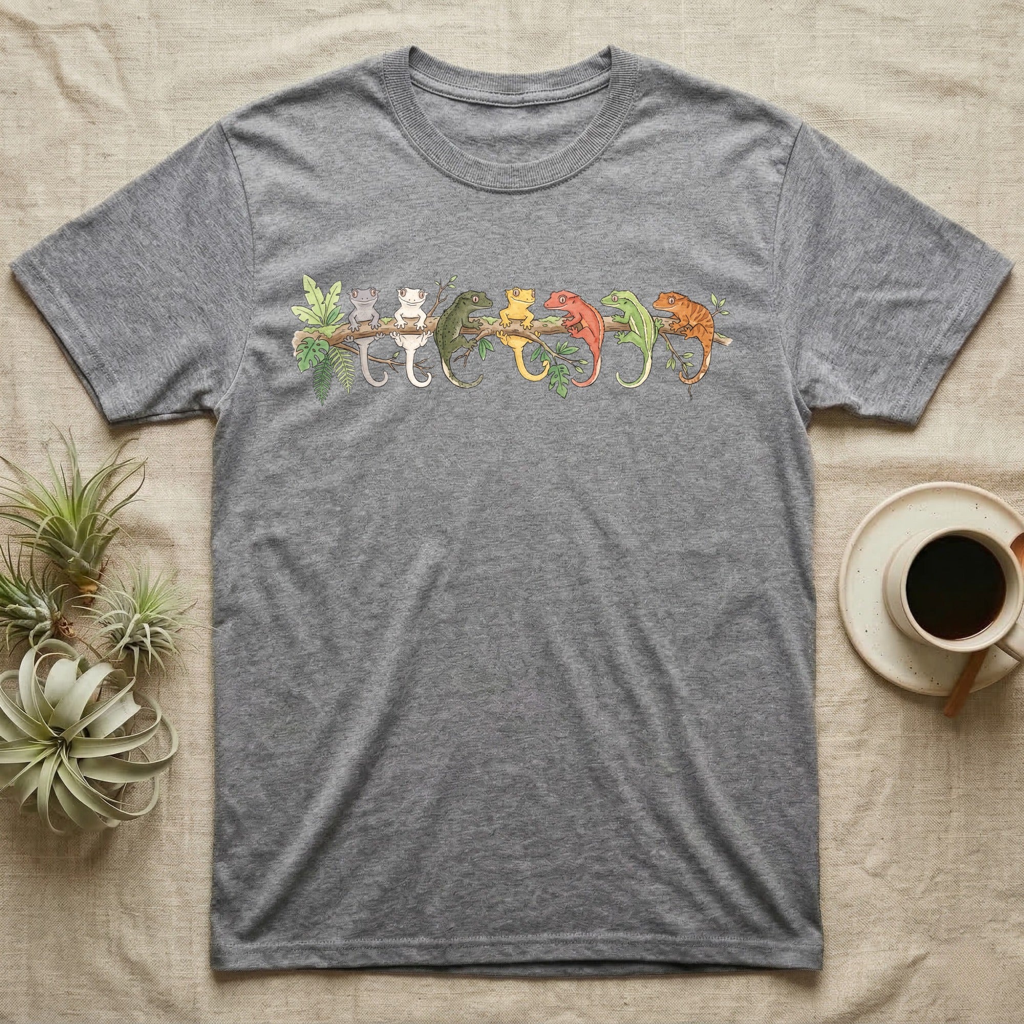 Crested Gecko Canopy Crew T-Shirt in Sport Grey — Watercolor illustration of seven crested gecko colour morphs perched on a branch, dark grey T-shirt design.