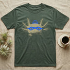 Axolotl Robber Mask T-Shirt in Military Green — An axolotl's face with a blue marker burglar mask and beanie drawn on the glass.