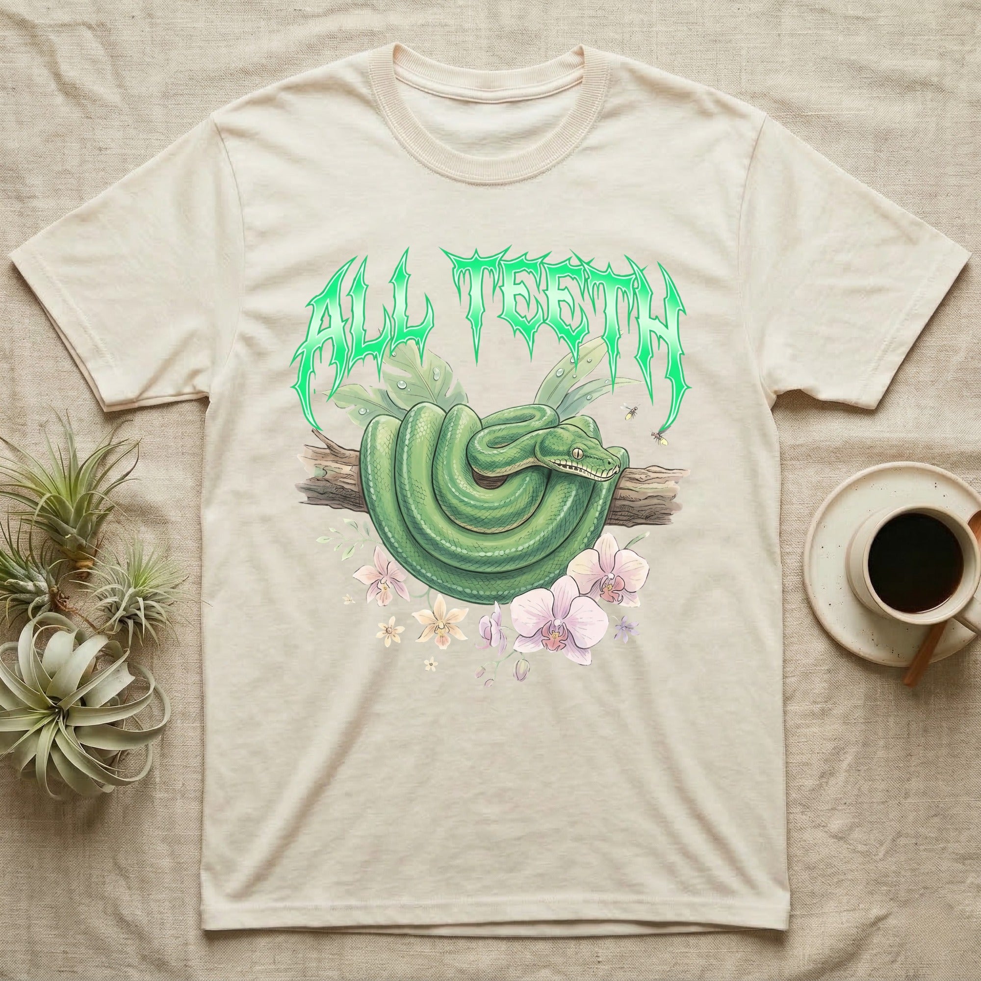Emerald Tree Boa Feral T-Shirt in Natural — Coiled emerald tree boa on a branch below a dripping emerald-green metal "All Teeth" wordmark