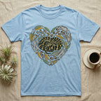 Blue t-shirt with a coiled snake and natural elements arranged in a heart shape.