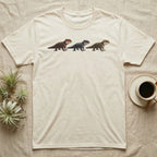 Crocodile Skink Morph Triptych T-Shirt in Natural — Three red-eyed crocodile skinks in a row, painted in thick impasto — bronze, near-black and pale olive forms.