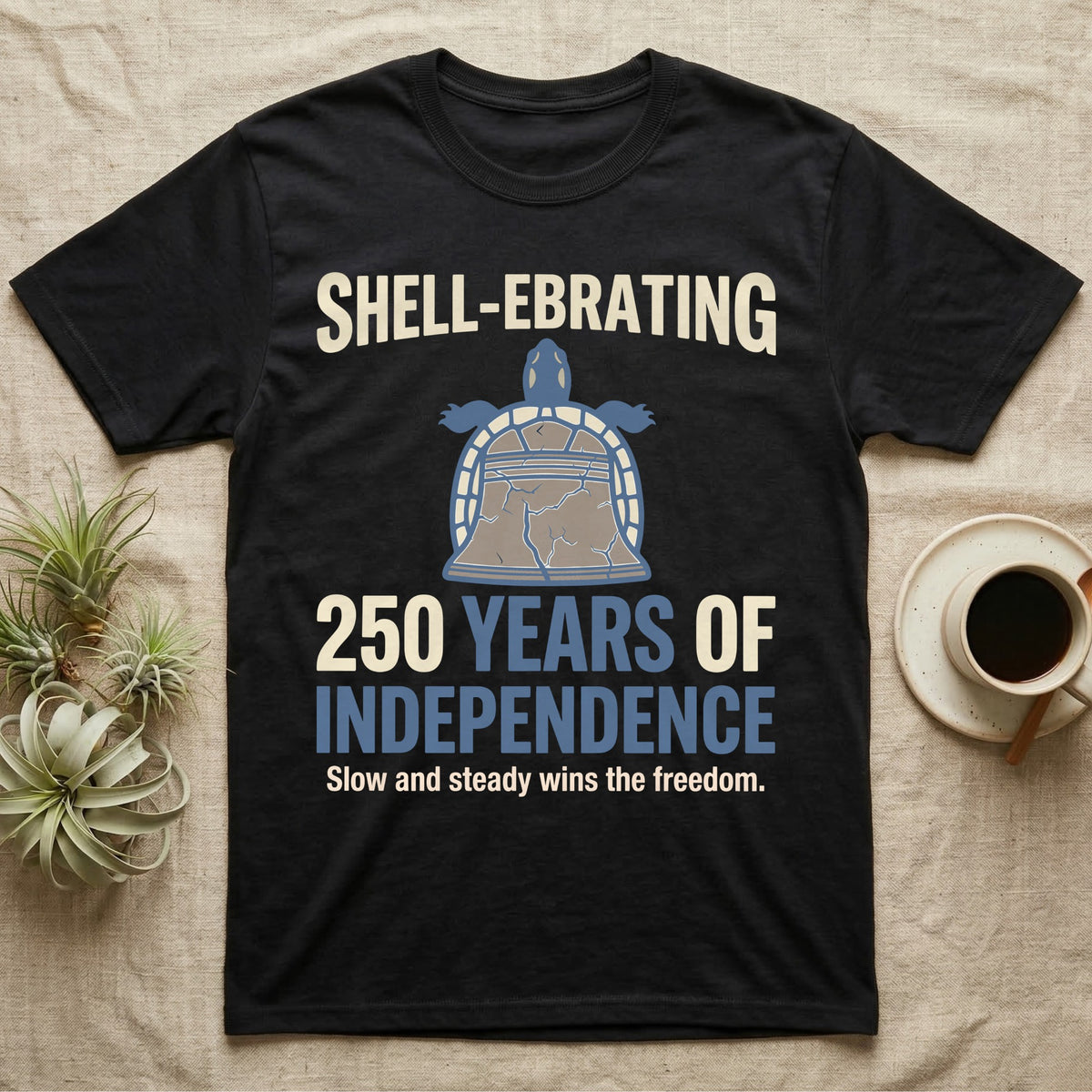 Sea Turtle Liberty Bell T-Shirt in Black — Slate-blue and cream tee of a sea turtle whose shell is drawn as the Liberty Bell under Shell-Ebrating 250 Years text.