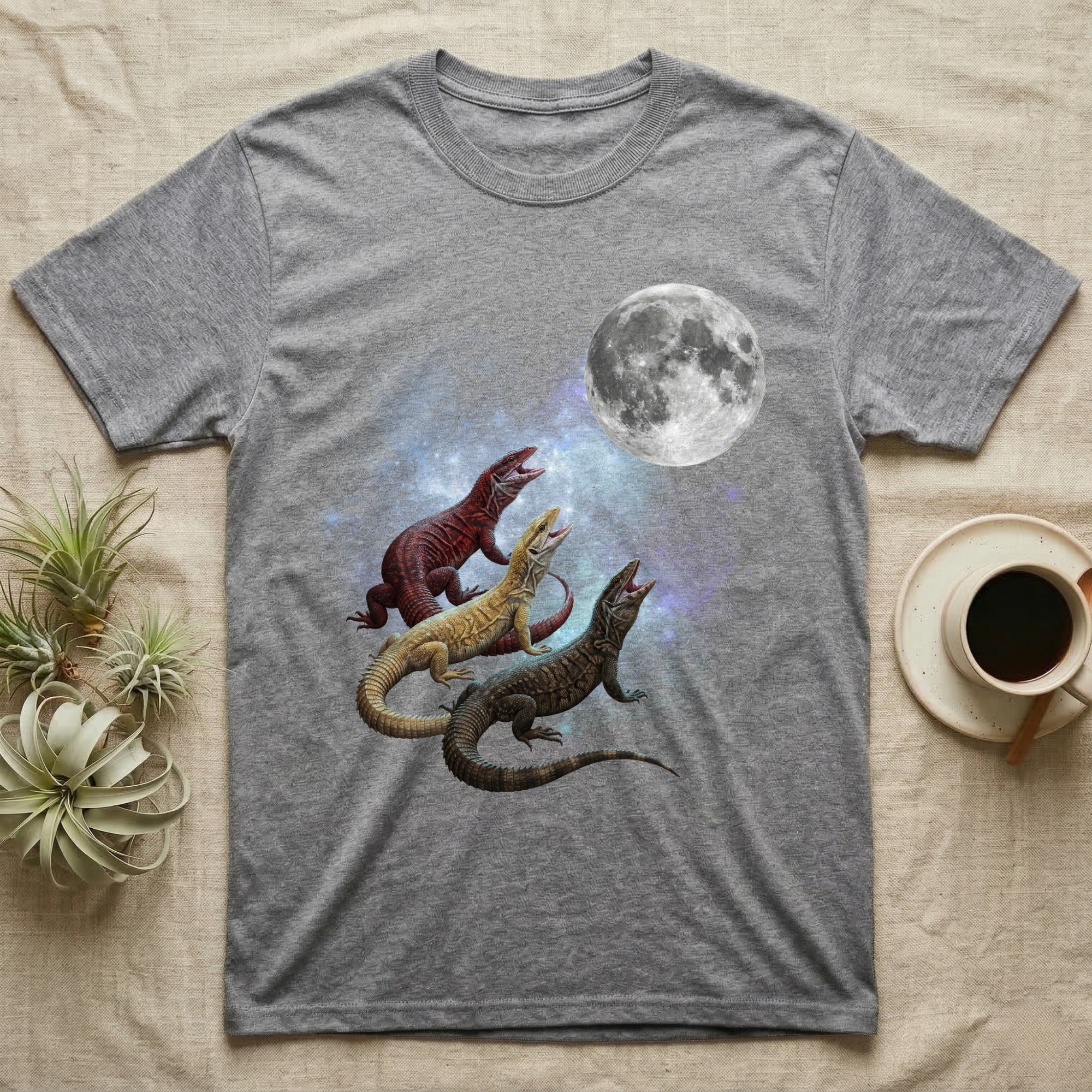 Ackie Monitor Moon Howl T-Shirt in Sport Grey — Three Ackie Monitor colour morphs howling at a full moon over a nebula on a dark grey t-shirt.