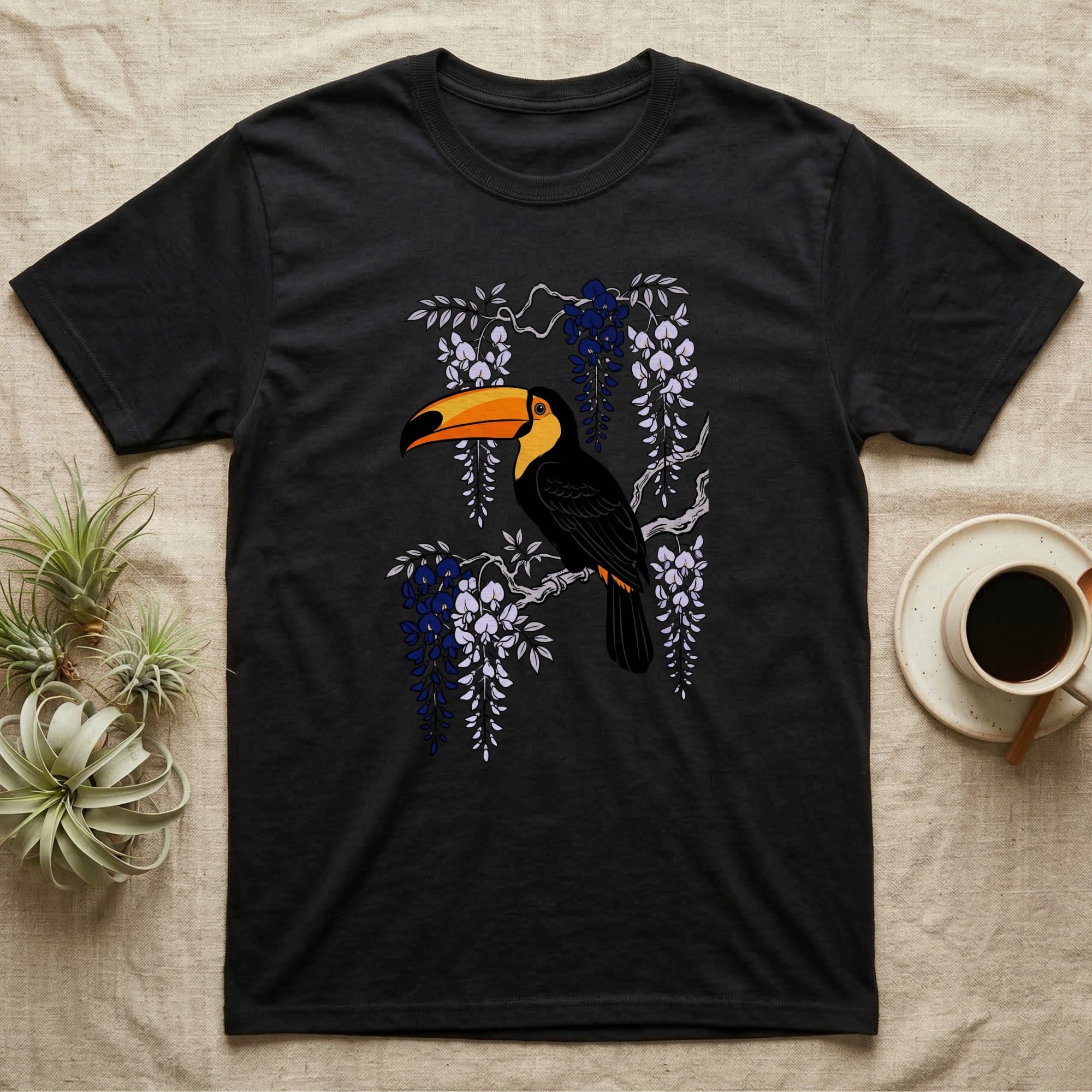 Black t-shirt with toucan and wisteria floral design.