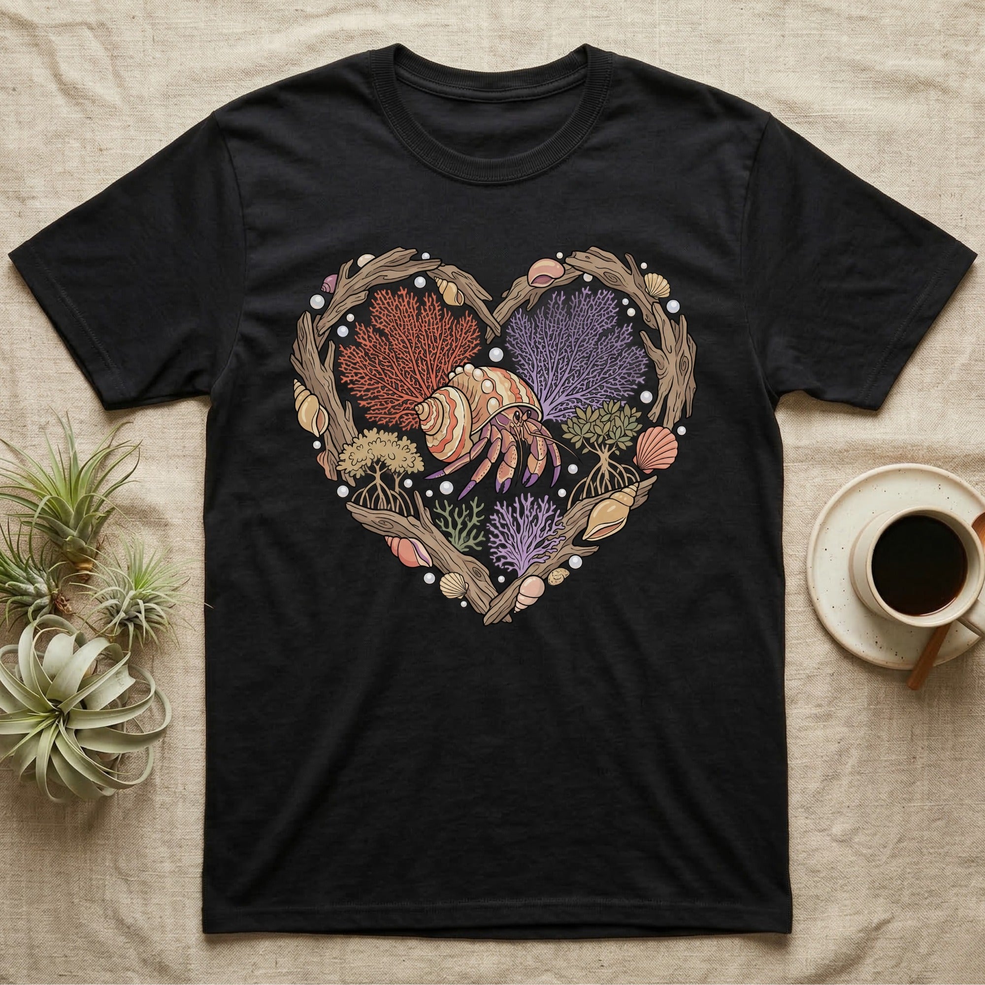 Black t-shirt with a heart-shaped design of shells, coral, and a hermit crab.