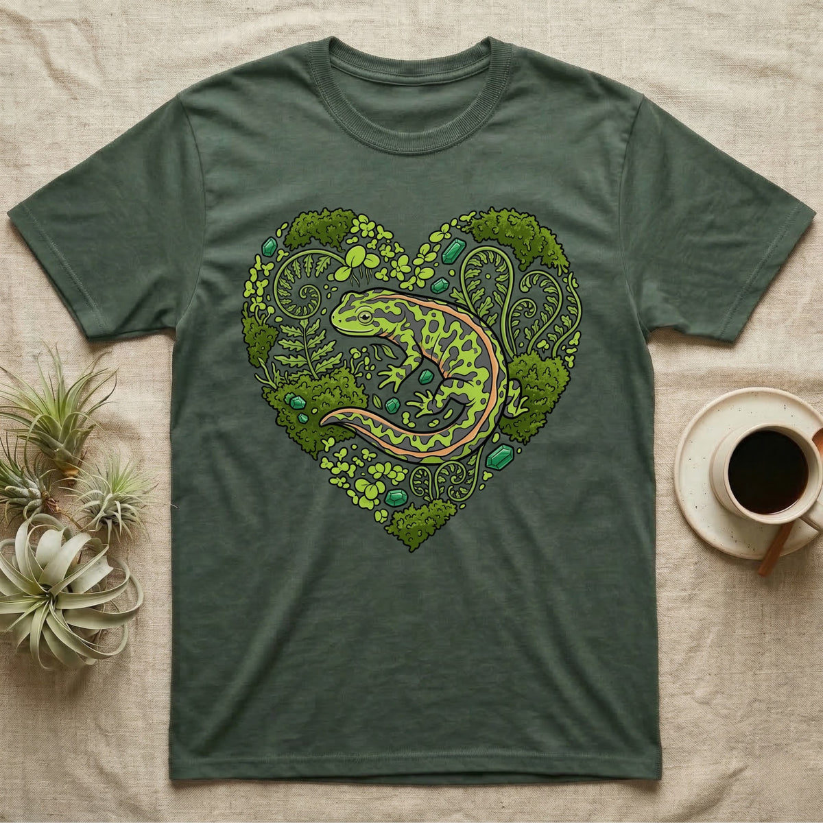 Green t-shirt with a stylized heart design featuring a salamander and foliage.