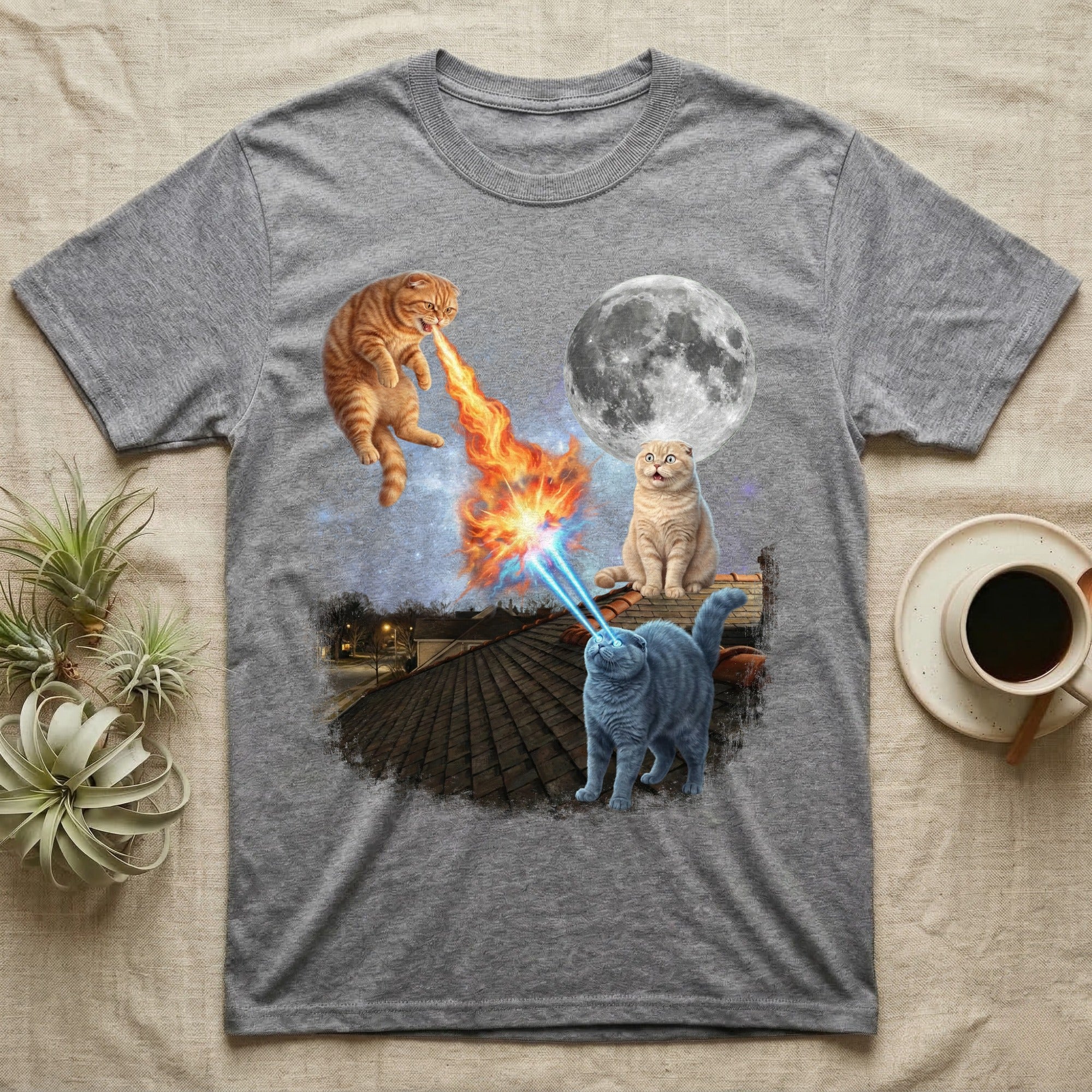 Two cats with lasers and fire, a moon, and cityscape on a gray t-shirt.