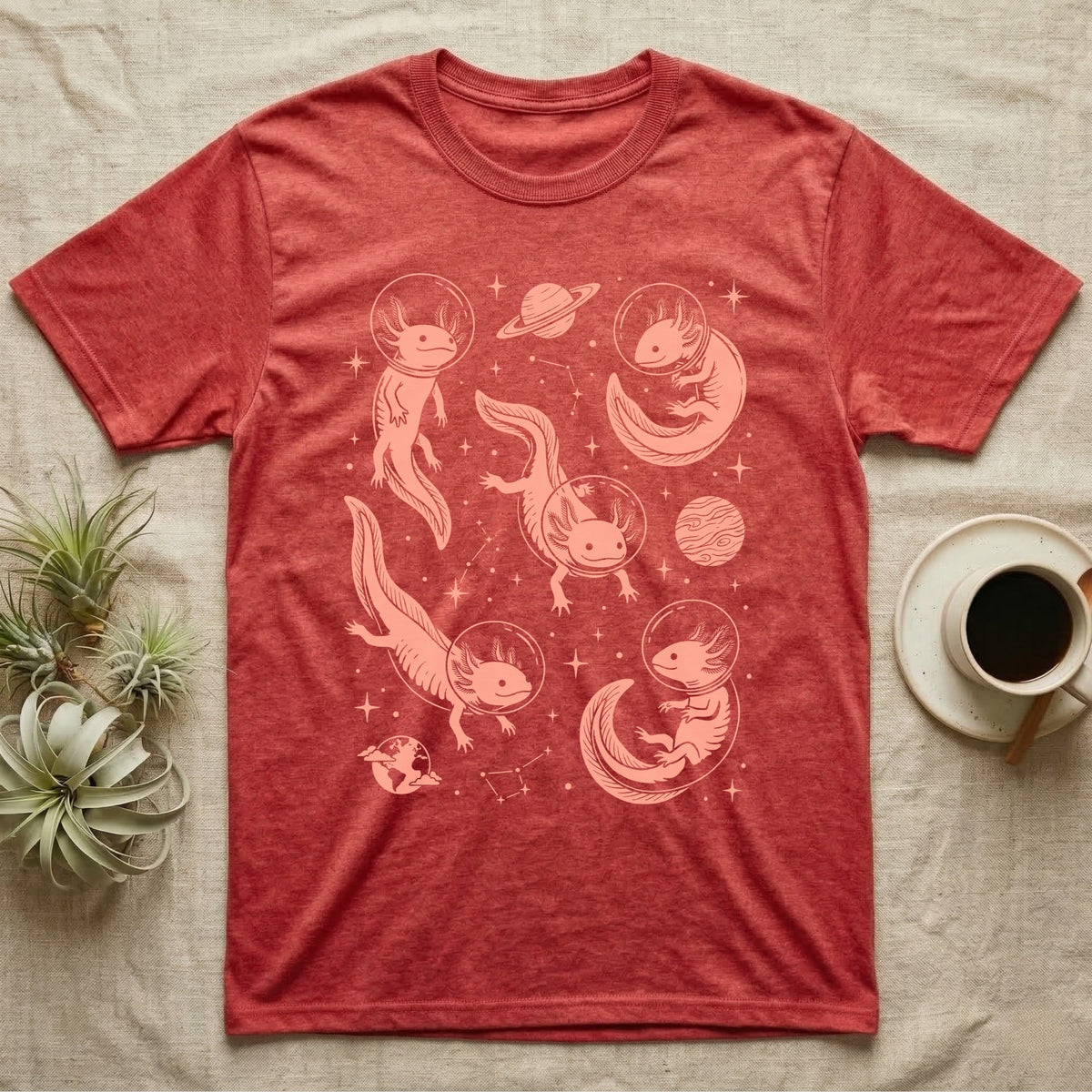 Axolotl Cosmic T-Shirt in Heather Red — Vintage screen-print illustration of axolotls in astronaut helmets floating in space, soft coral monochromatic on dark background.