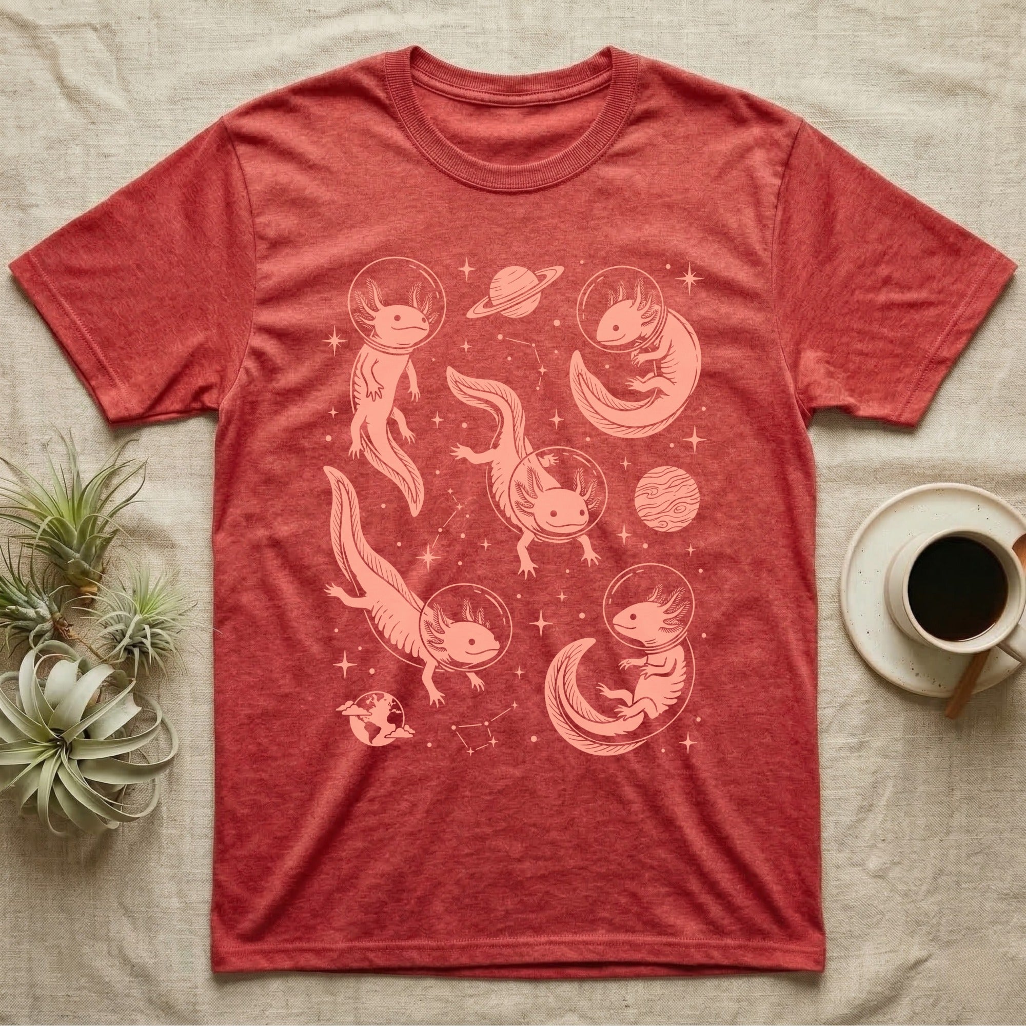 Axolotl Cosmic T-Shirt in Heather Red — Vintage screen-print illustration of axolotls in astronaut helmets floating in space, soft coral monochromatic on dark background.