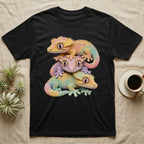 Three colorful geckos stacked on a black t-shirt.