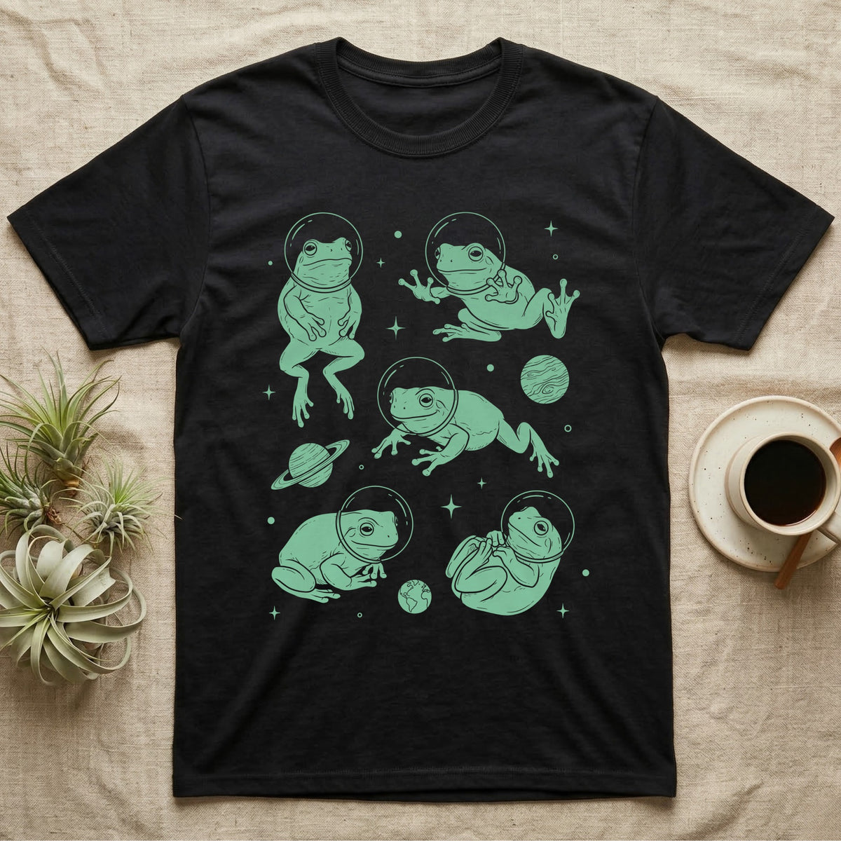 Whites Tree Frog Cosmic T-Shirt in Black — Vintage screen-print illustration of White's tree frogs in astronaut helmets floating in space, cosmic jade green monochromatic on dark background.