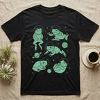 Whites Tree Frog Cosmic T-Shirt in Black — Vintage screen-print illustration of White's tree frogs in astronaut helmets floating in space, cosmic jade green monochromatic on dark background.