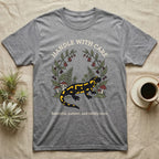 Fire Salamander Poison Plate T-Shirt in Sport Grey — Naturalist apothecary-plate illustration of a fire salamander framed by a symmetric wreath of woodland botanicals.