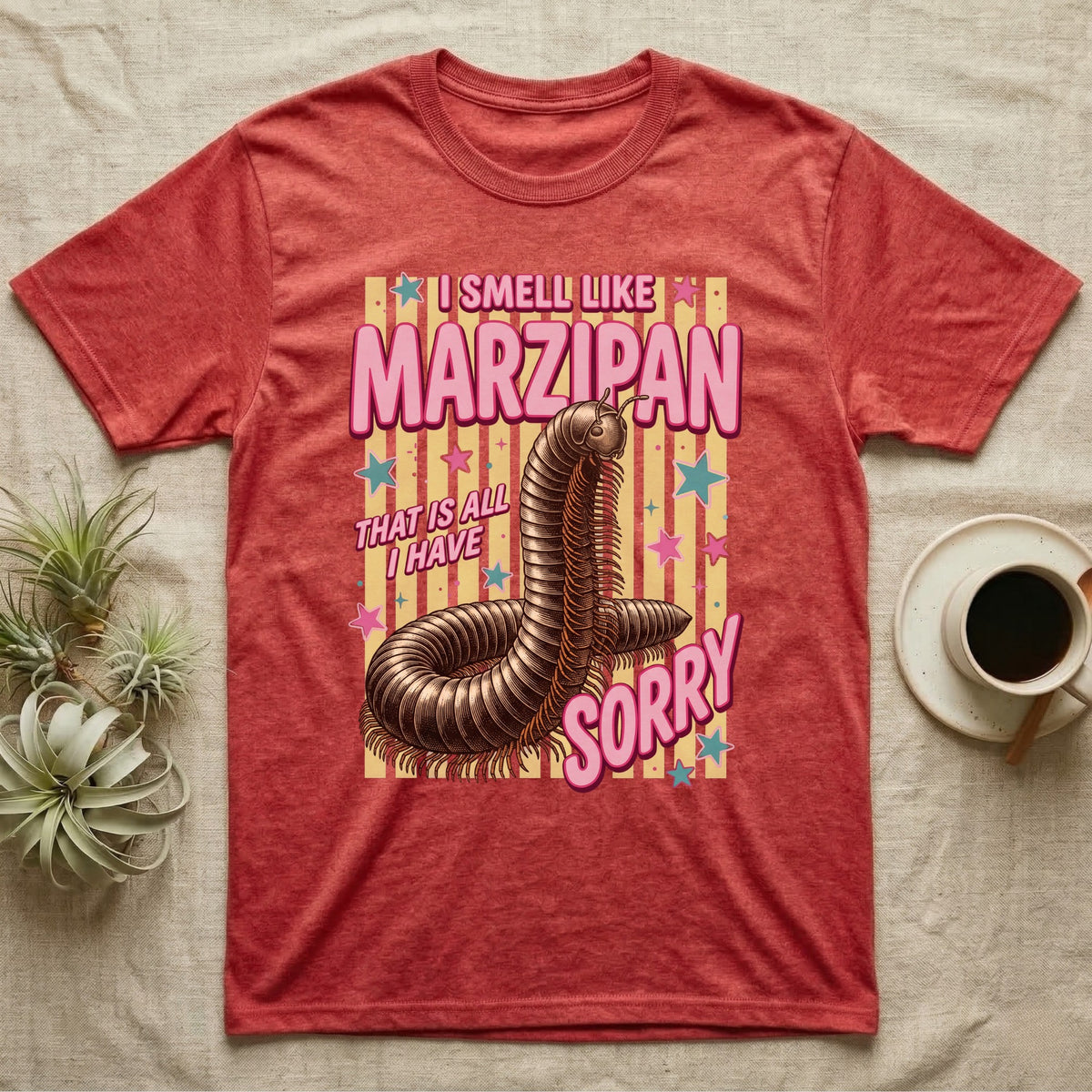 Millipede Almond Defence T-Shirt in Heather Red — Engraved giant African millipede coiled upright under fat pink club lettering reading ALMOND DEFENCE on yellow stripes.