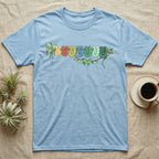 Green Tree Python Canopy Crew T-Shirt in Light Blue — Watercolor illustration of a green tree python in seven real colour-change stages coiled on a branch, dark grey T-shirt design.