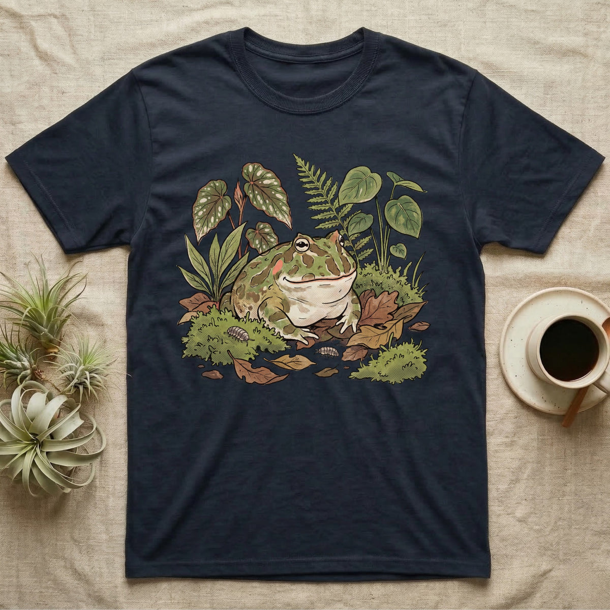 Bioactive Pacman Frog T-Shirt in Navy — Warm botanical illustration of a content pacman frog half-buried in a lush bioactive habitat of moss and leaf litter.