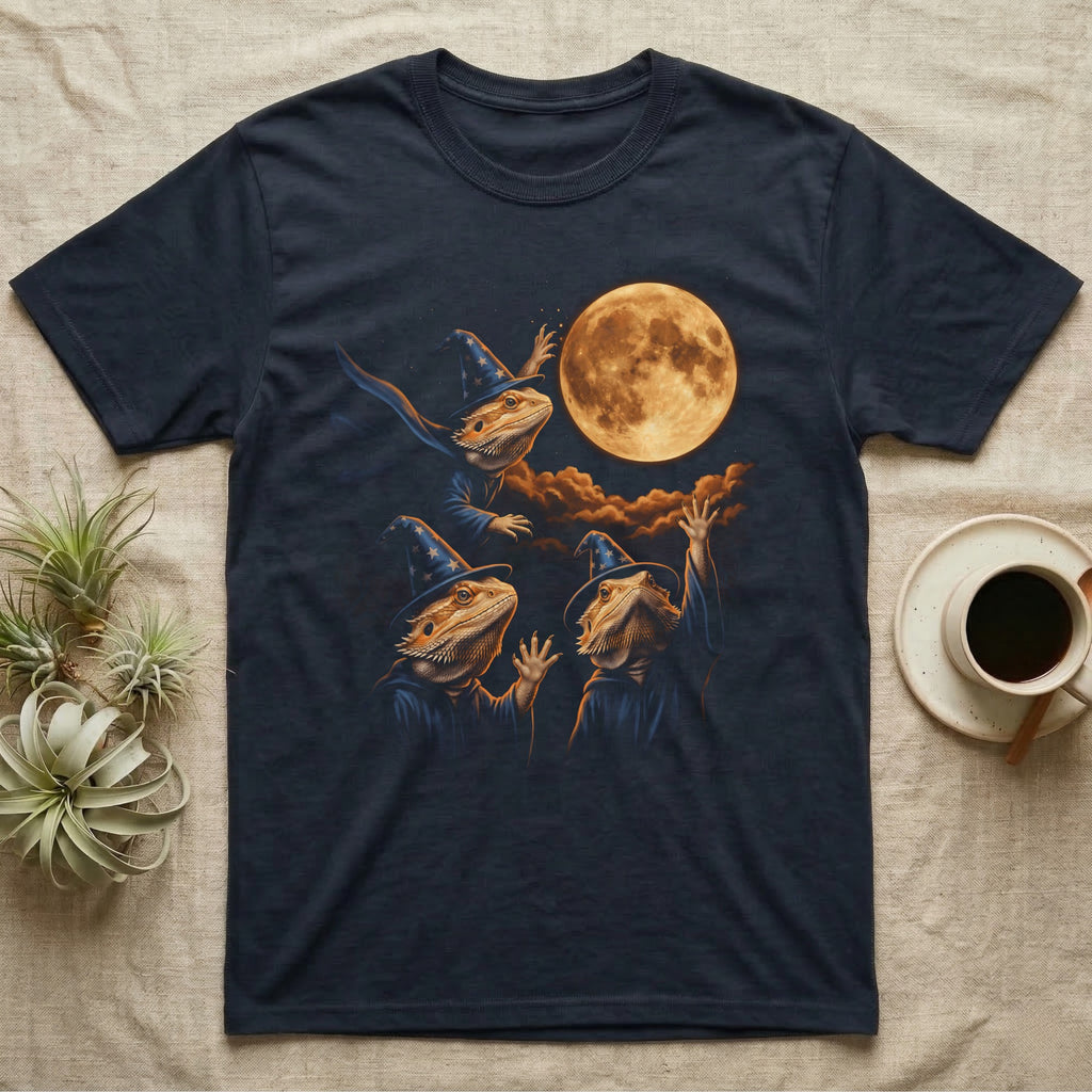 Bearded Dragon Wizard T-Shirt in Navy — Three bearded dragons in blue wizard hats and robes under a glowing amber full moon, one casting sparks, two waving up