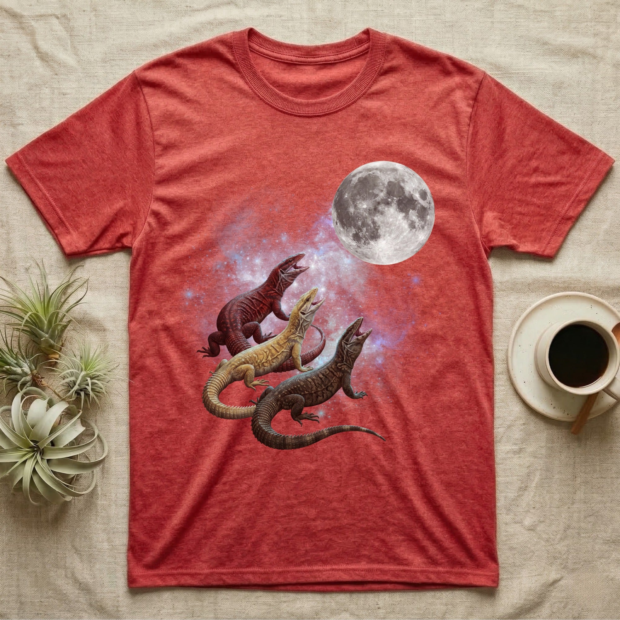 Ackie Monitor Moon Howl T-Shirt in Heather Red — Three Ackie Monitor colour morphs howling at a full moon over a nebula on a dark grey t-shirt.