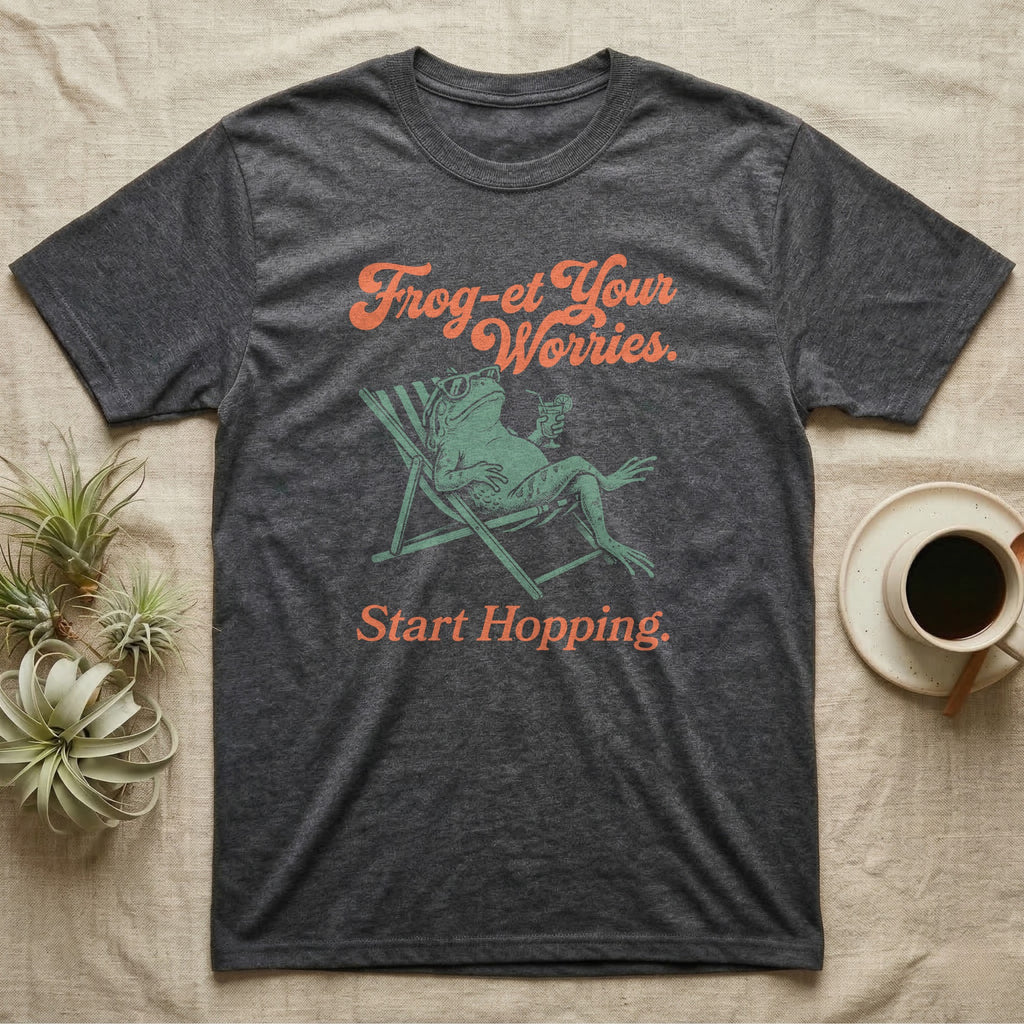 Cane Toad Sun Lounger T-Shirt in Dark Heather — Illustrated cane toad reclining in a beach chair with sunglasses and a cocktail, coral script reading Frog-et Your Worries Start Hopping.