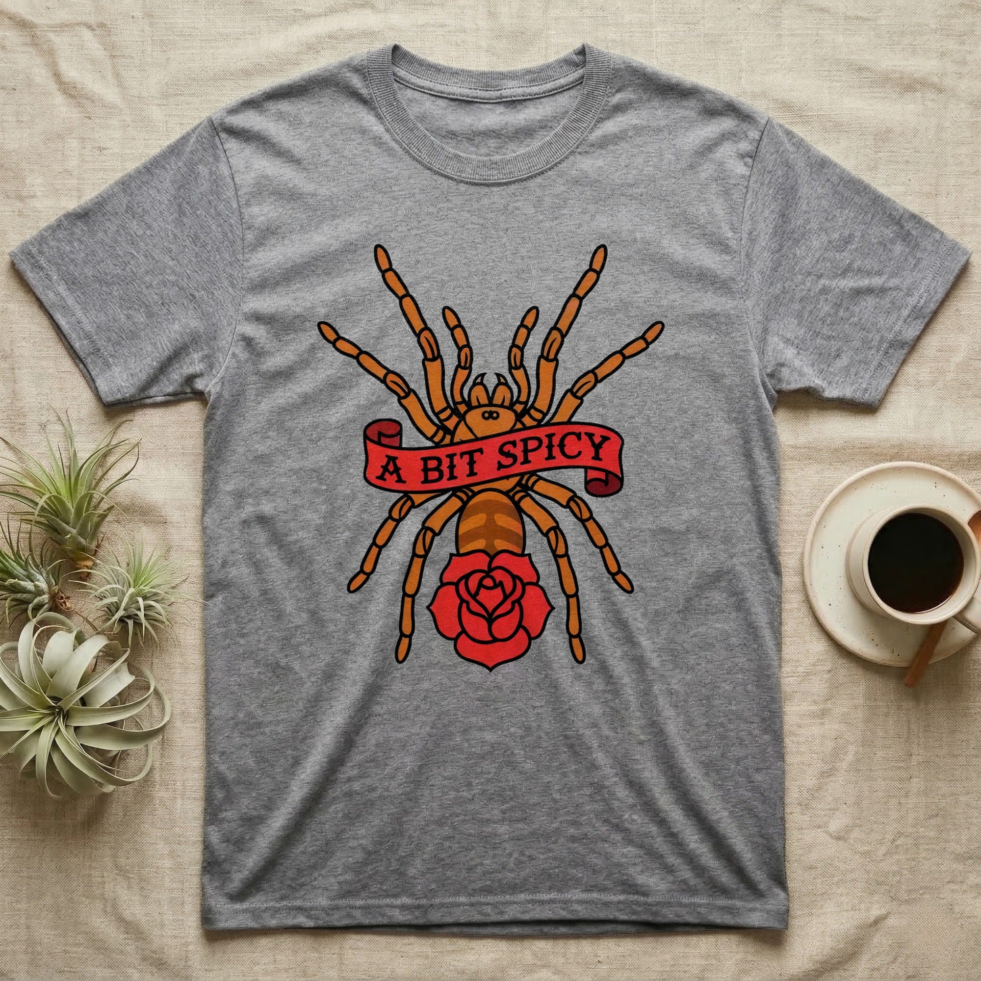 Tarantula A Bit Spicy T-Shirt in Sport Grey — Tattoo-flash orange-baboon-tarantula in threat-pose with banner-scroll "A Bit Spicy" and a flash rose beneath.