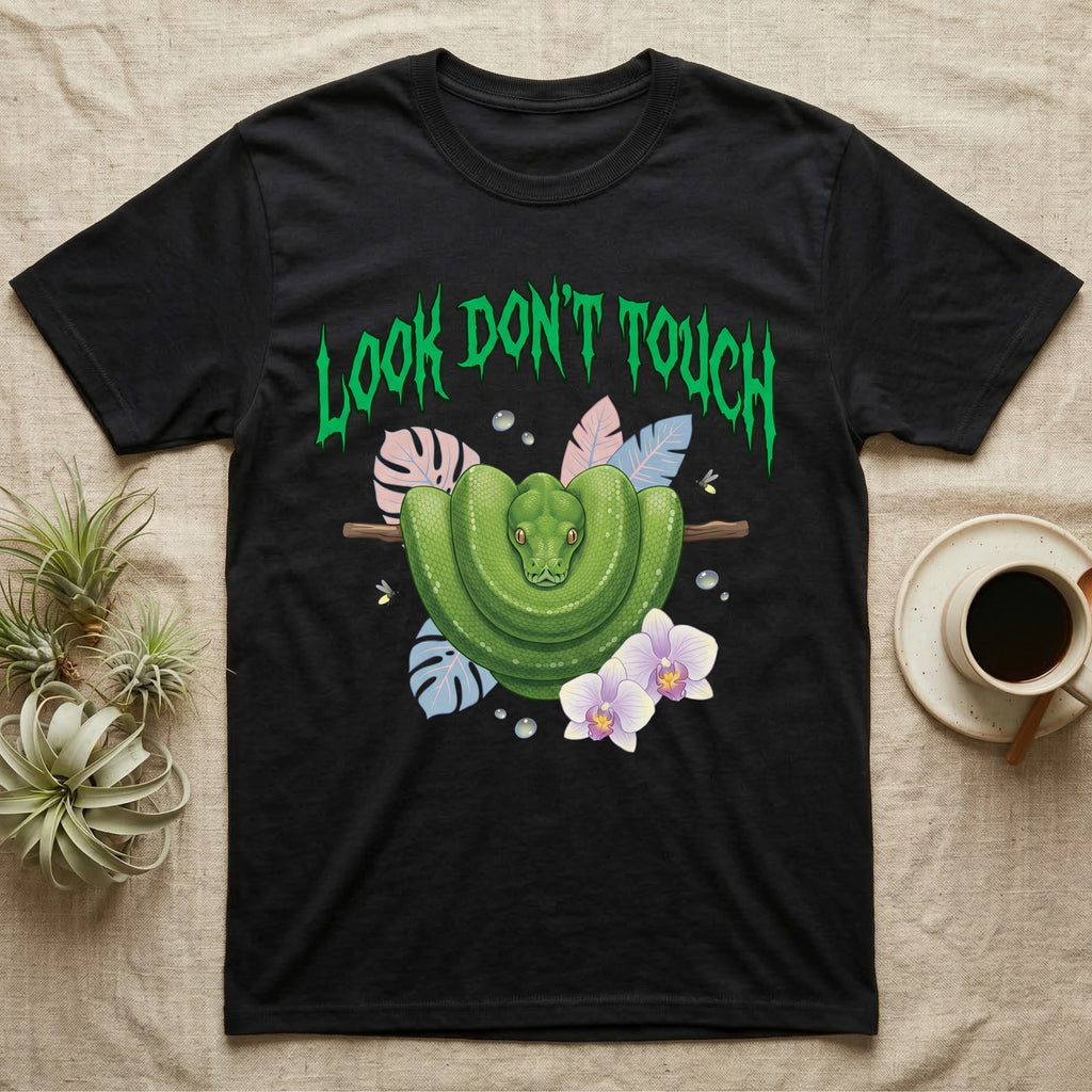 Green Tree Python Feral T-Shirt in Black — Green tree python in a saddle coil on a branch under a jagged emerald metal "LOOK DON'T TOUCH" wordmark and orchids.