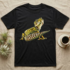 Illustration of a smiling leopard gecko with a plump curled spotted tail, bold vintage-comic ink outlines and halftone shading, graphic-only, no text. — shown on a Black tee.