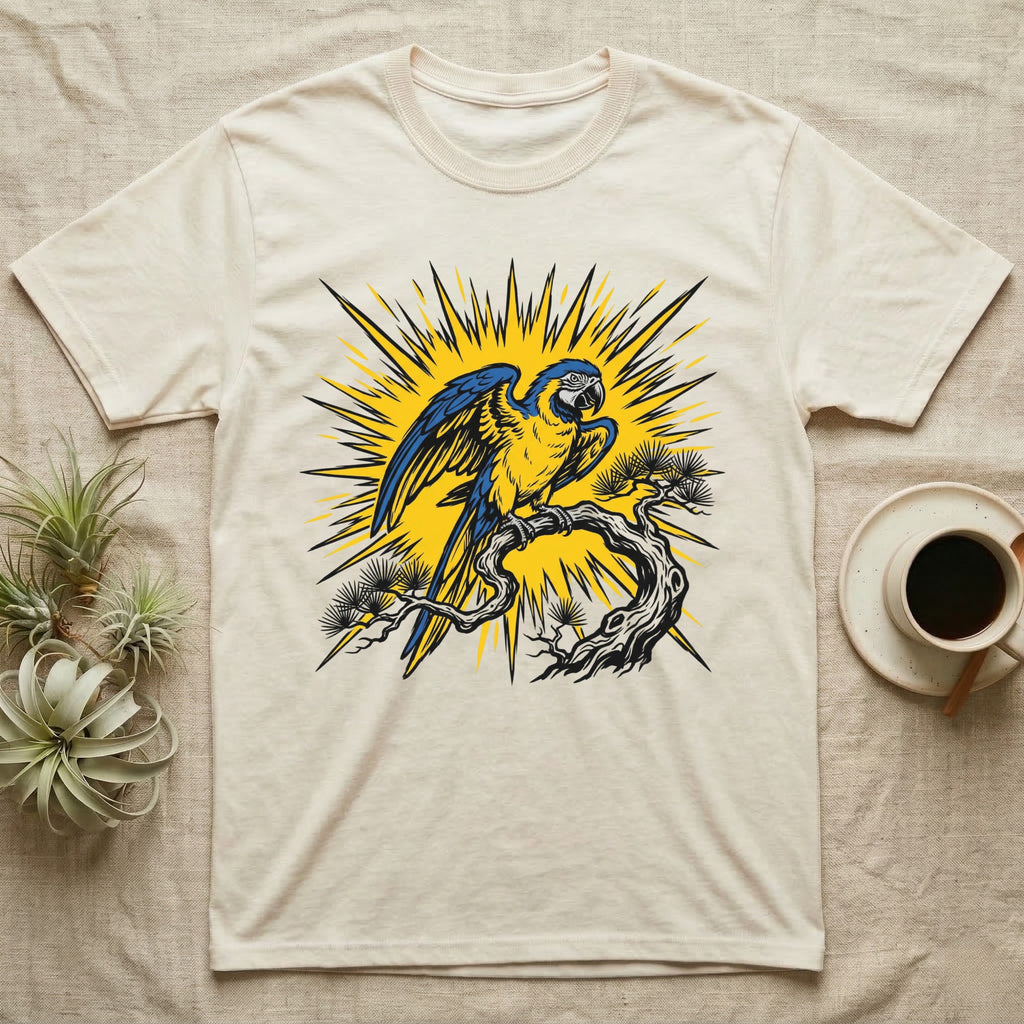 Yellow and blue macaw perched on a branch, sunburst background on a cream t-shirt.