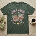 Rosy Boa Softie T-Shirt in Military Green — Relaxed coiled rosy boa with sleepy eyes under pastel bubble text "just chill" with tiny hearts.