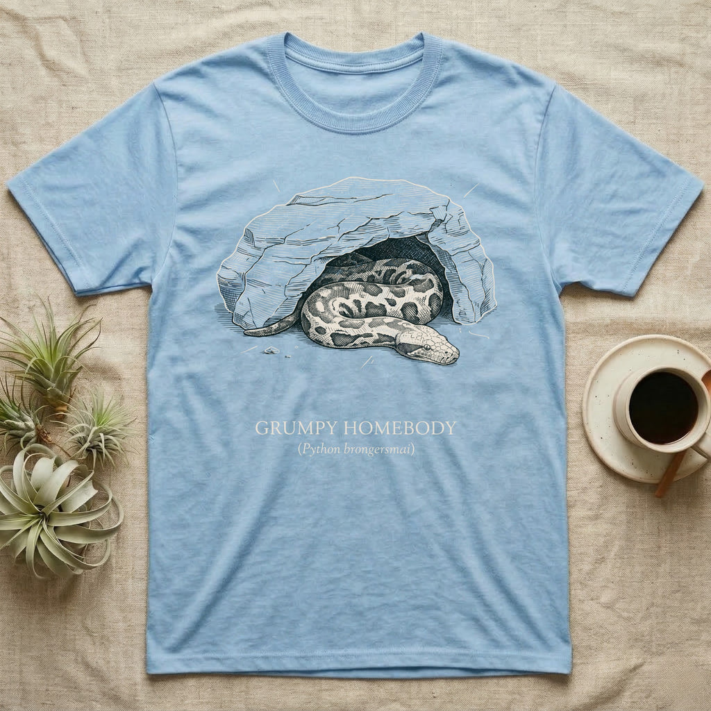 Blood Python Grumpy Homebody T-Shirt in Light Blue — Naturalist ink engraving of a blood python resting in a rock cave, captioned "Grumpy Homebody, Python brongersmai".