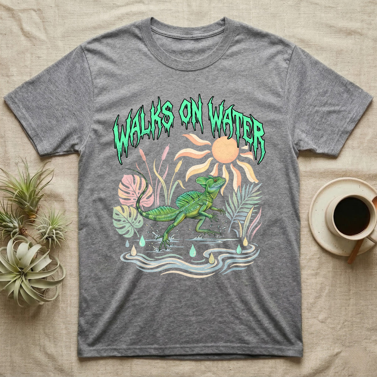 Green Basilisk Feral T-Shirt in Sport Grey — Green plumed basilisk sprinting across water below a dripping aqua-green metal "Walks On Water" wordmark