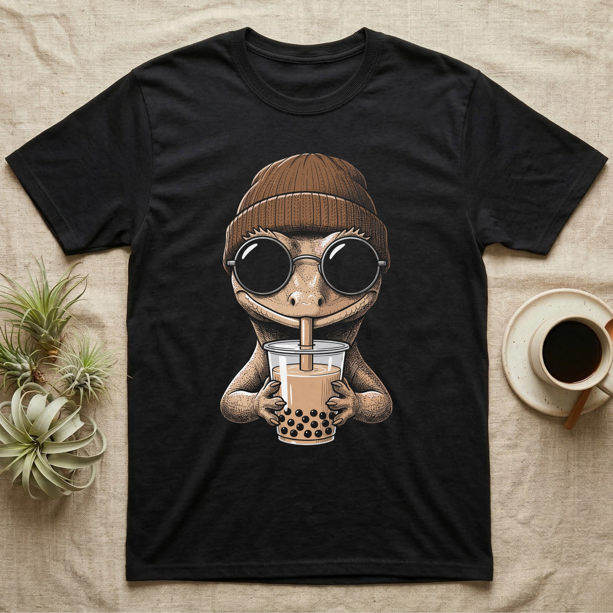 Crested Gecko Boba Tea T-Shirt in Black — Cross-hatch engraving of a crested gecko in a beanie and round glasses sipping boba milk tea.