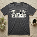 Bearded Dragon Basking Silhouette T-Shirt in Dark Heather — Cream bearded dragon silhouette nested into distressed block text reading Don't Tread On Me, I'm Basking.
