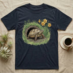 Russian Tortoise Spring T-Shirt in Navy — Botanical illustration of a Russian tortoise stepping into spring grass framed by daffodils and early shoots.