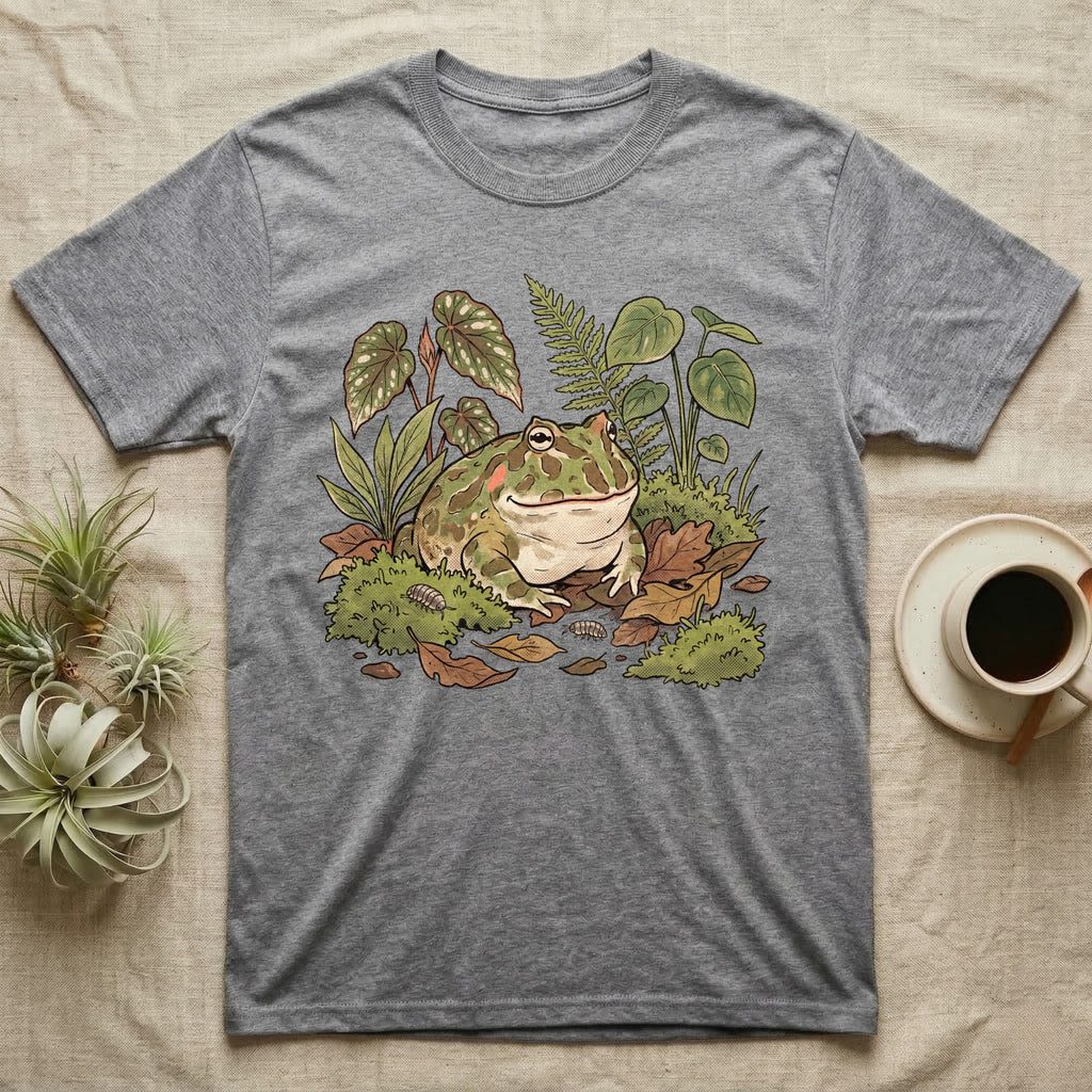 Bioactive Pacman Frog T-Shirt in Sport Grey — Warm botanical illustration of a content pacman frog half-buried in a lush bioactive habitat of moss and leaf litter.