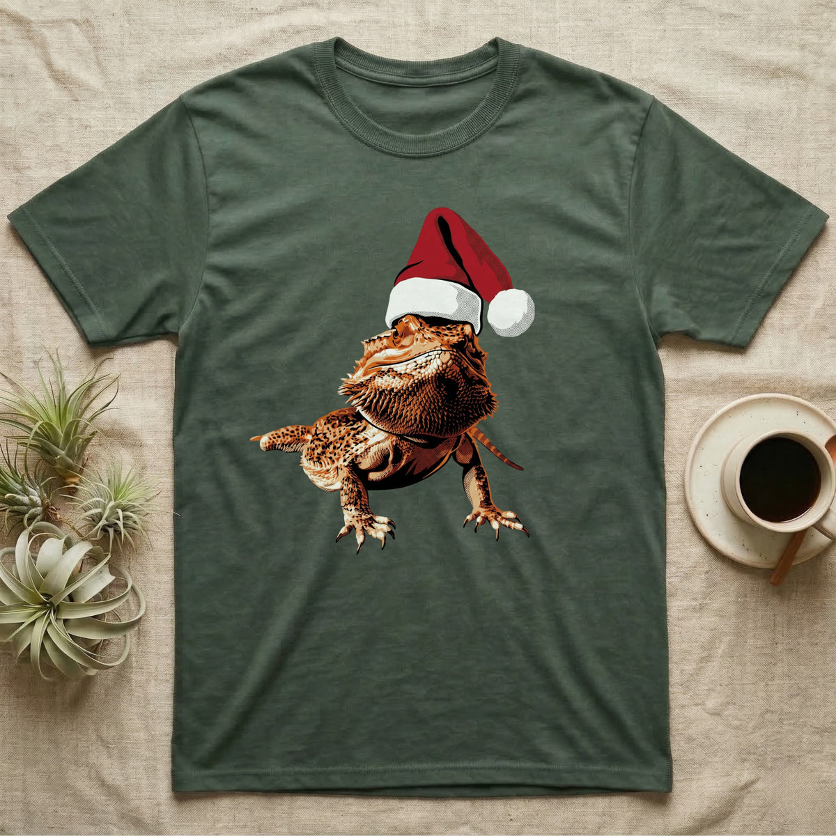 Vintage comic illustration of a bearded dragon wearing a red and white Santa hat, graphic-only, no text. — shown on a Military Green tee.